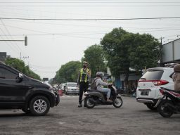 Kasatlantas Polres Ponorogo AKP Ayip Rizal saat mengatur lalu lintas.(Foto: Mita Kusuma/jatimnow.com)