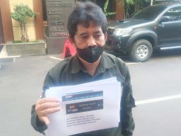 Ketua Ormas Macita, Mohammad Hasan saat mengadukan Ketua Komas PA di Polda Jatim (Foto: Zain Ahmad/jatimnow.com)