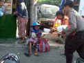 Anggota Polres Magetan melaksanakan program Jumat Berkah dengan membagikan nasi kotak