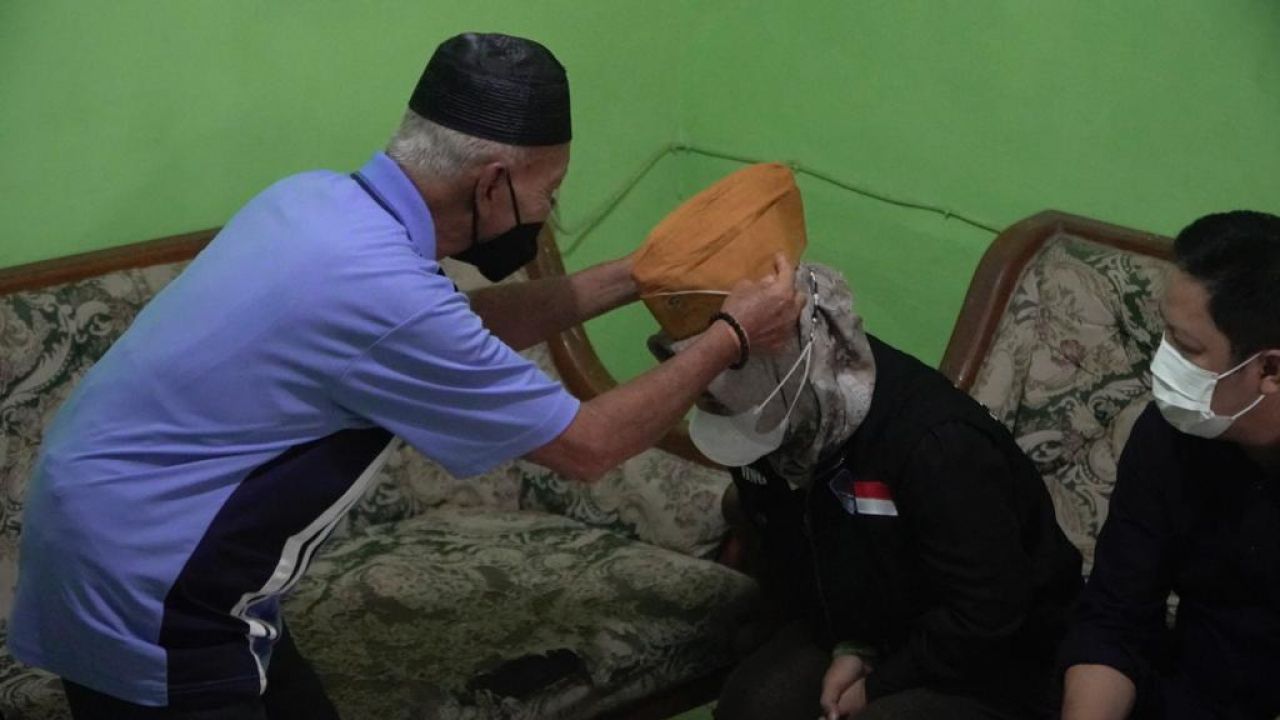 Veteran perang memakaikan topi baret kepada Wali Kota Mojokerto Ika Puspitasari.