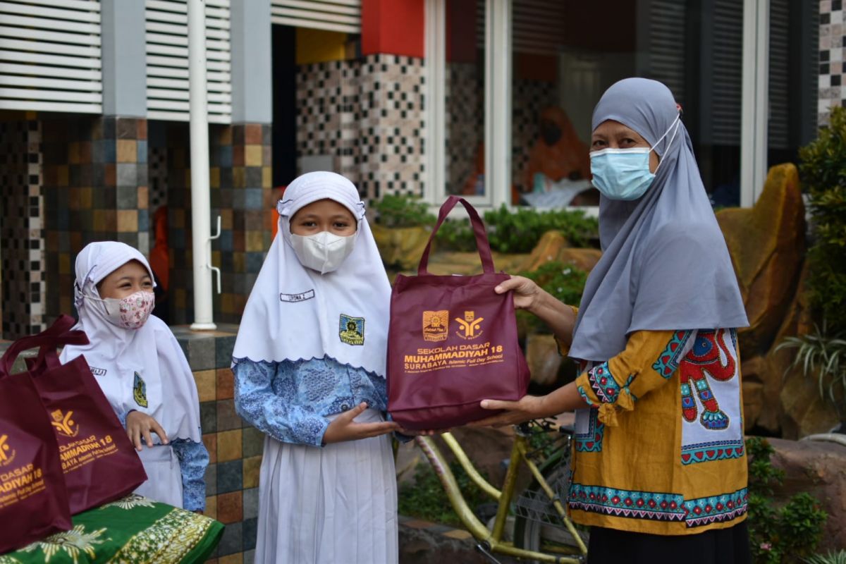 Para siswa SD Muhammadiyah 18 Surabaya saat melayani warga yang menukarkan botol plastik bekas dengan sembako
