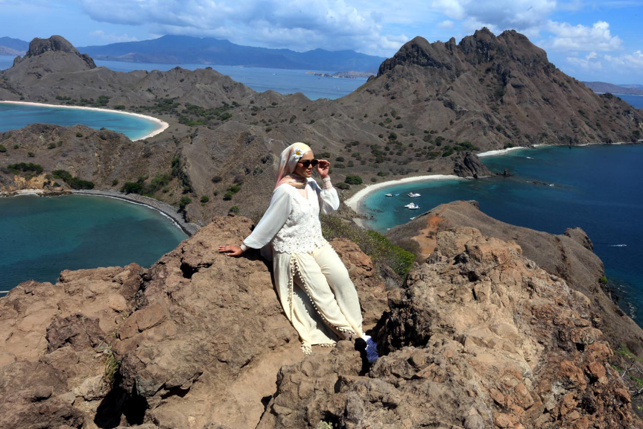 Seorang wisatawan menikmati panorama dari puncak Pulau Padar, Taman Nasional Komodo, Kabupaten Manggarai Barat, Nusa Tenggara Timur, Sabtu (08/11/2025). (Foto: Ali Masduki/JatimNow.com)