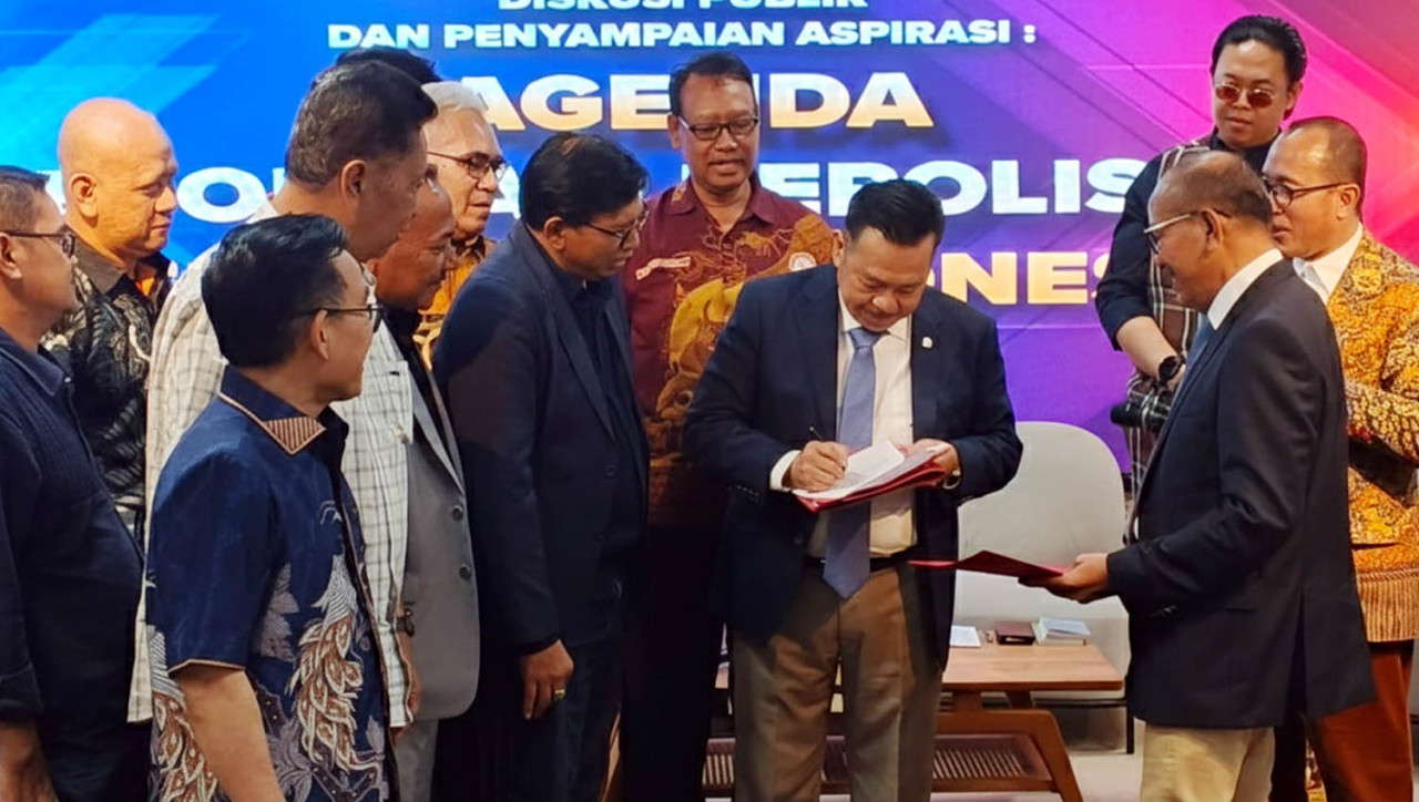 Tim Percepatan Reformasi Polri, Prof. Otto Hasibuan, menandatangangi masukan tertulis dari berbagai organisasi dan akademisi, di Unair Surabaya, Kamis (27/11/2025). (Foto: Ali Masduki/jatimnow.com)