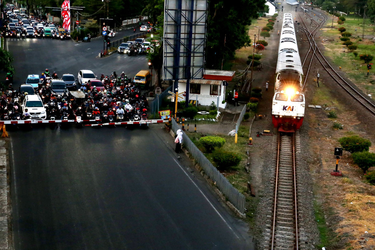 Kereta Api melintas di kawasan Wonokromo Surabaya. Kereta api kembali menjadi andalan masyarakat untuk menikmati Libur Natal 2025 dan Tahun Baru 2026 (Nataru). (Foto: Ali Masduki/JatimNow.com)