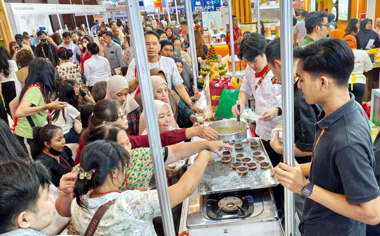 Pengunjung antri mencicipi soup kaki sapi khas Nyonya Lim di stand Rose Brand dalam gelaran IIFEX 2026 di Grand City Convention Hall Surabaya, Sabtu (20/6/2026) malam. (Foto: Ali Masduki/jatimnow.com)