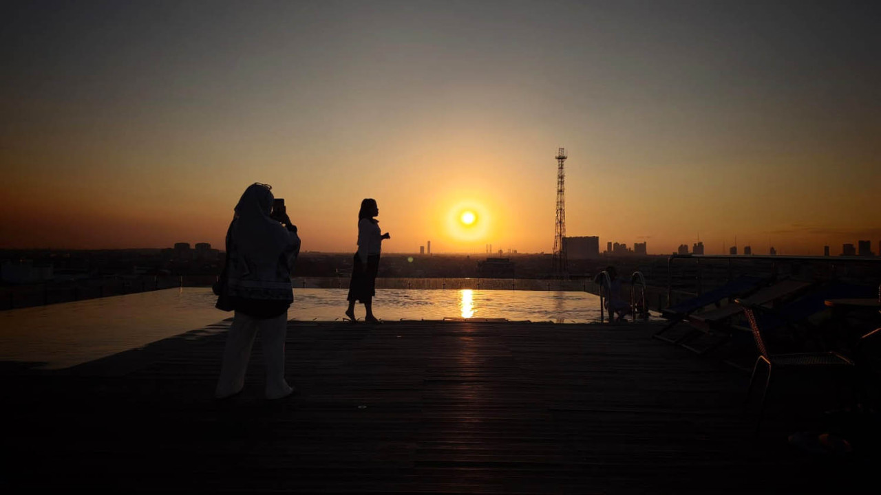 Tamu Anios Restaurant menikmati senja di rooftop EXCOTEL Surabaya, Jumat (07/8/2026). (Foto: Ali Masduki/jatimnow.com)