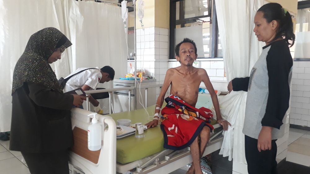 Eko Sumantoyo, guru honorer penderita pembekuan darah di otak dirawat di rumah sakit, ditemani Siti Syamsiyah, istrinya