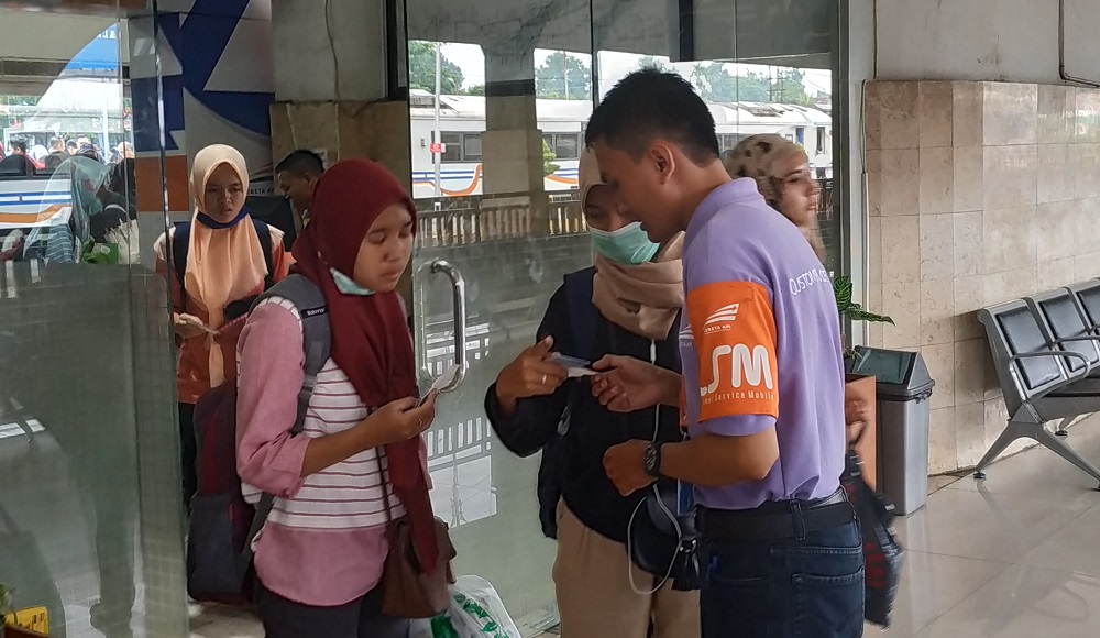 Personel tambahan customer service mobile Stasiun Malang Kota Baru melayani penumpang dengan jemput bola. 
